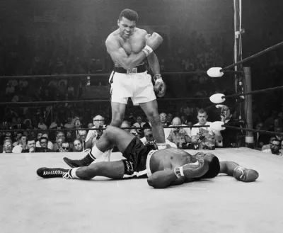 Iconic picture of Muhammad Ali towering over a rival