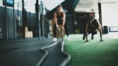 two boxing athletes training with battle ropes in week 1 program